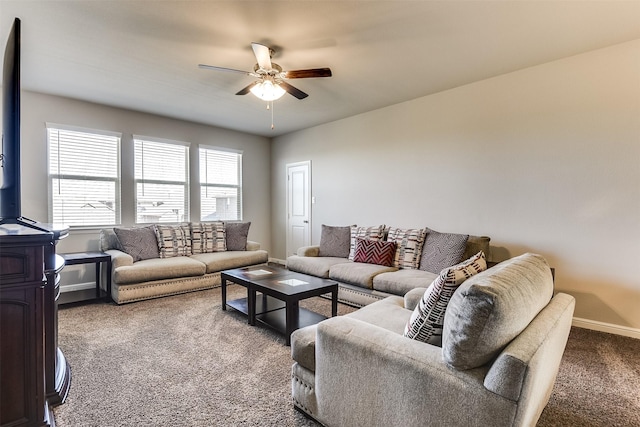 living area with carpet floors, a ceiling fan, and baseboards