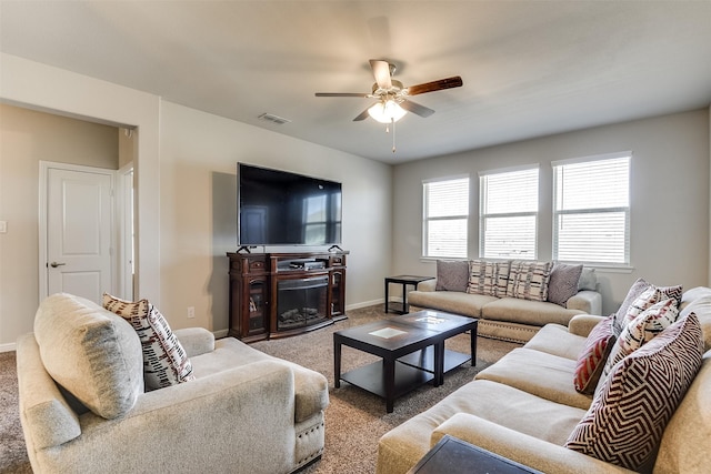 living room featuring ceiling fan, carpet floors, visible vents, and baseboards