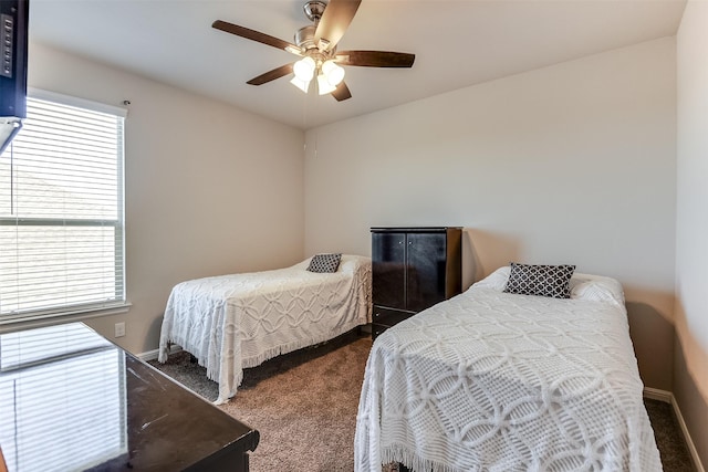 bedroom with dark carpet, baseboards, and ceiling fan