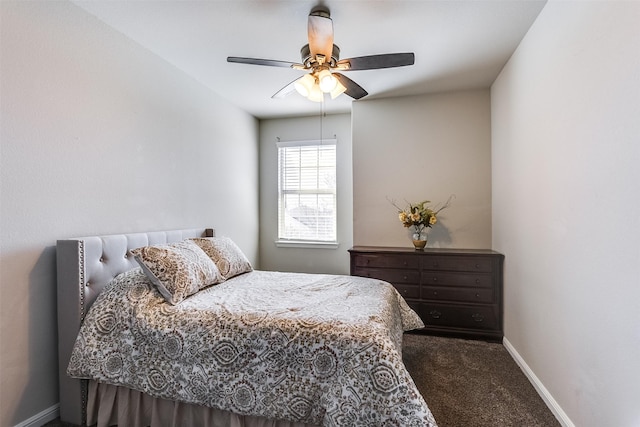 carpeted bedroom with ceiling fan and baseboards