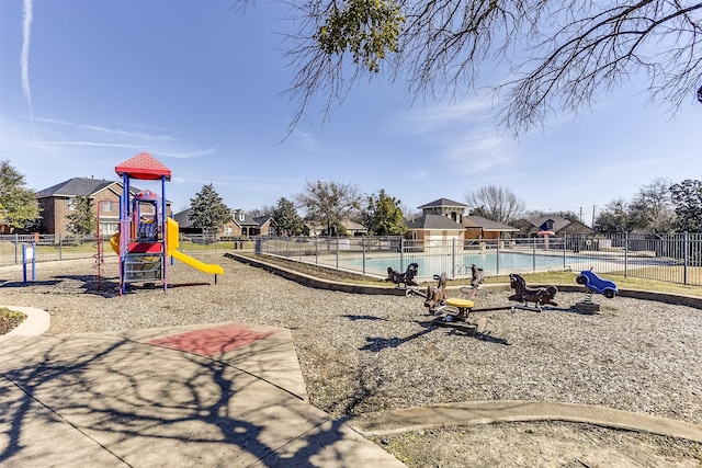 communal playground with a community pool and fence