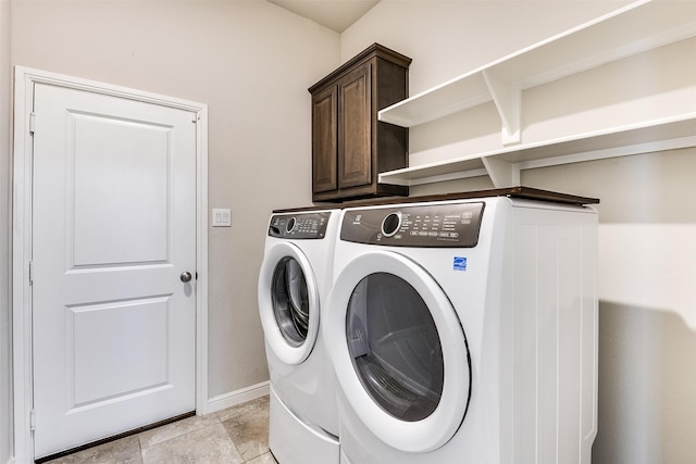 laundry area featuring cabinet space, washing machine and dryer, and baseboards