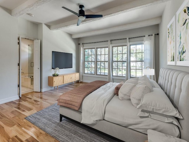 bedroom with ceiling fan, connected bathroom, baseboards, light wood-type flooring, and beam ceiling