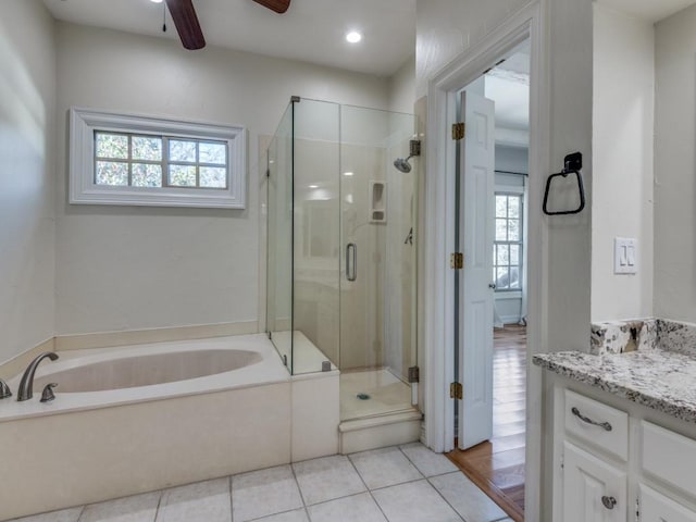 bathroom with tile patterned flooring, vanity, a ceiling fan, a shower stall, and a bath