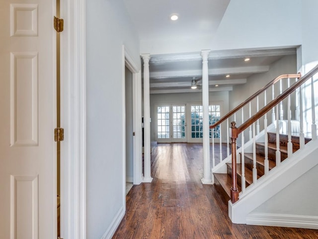 entrance foyer with dark wood-style floors, stairway, beamed ceiling, french doors, and ornate columns