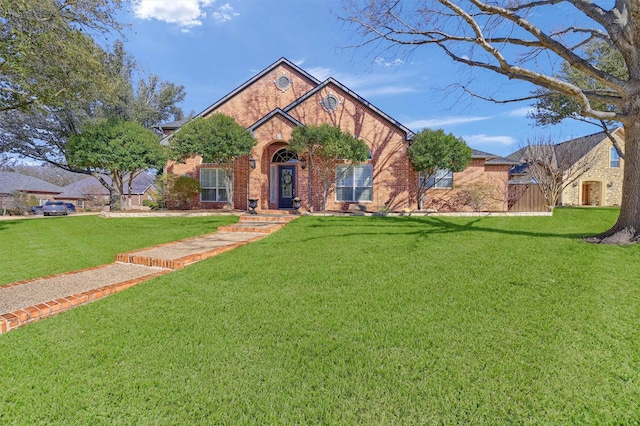 view of front of home with a front lawn and brick siding