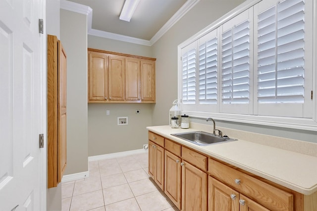 kitchen with light tile patterned floors, a sink, light countertops, light brown cabinetry, and crown molding