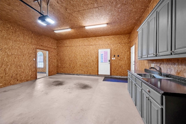 garage featuring a sink and a garage door opener