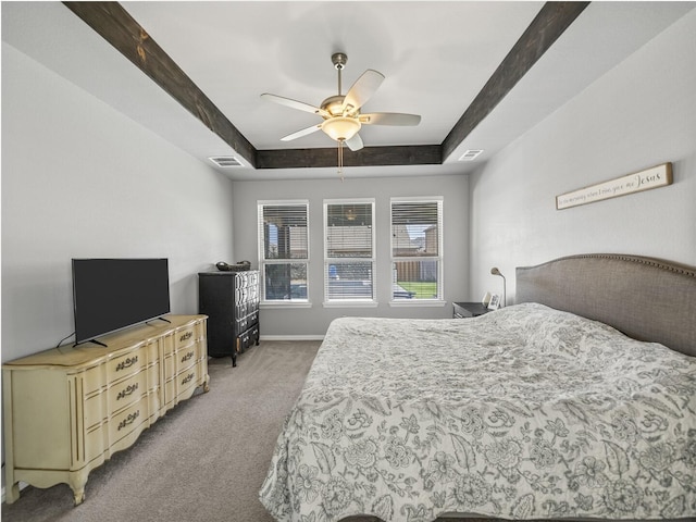 bedroom with light carpet, a raised ceiling, visible vents, and baseboards