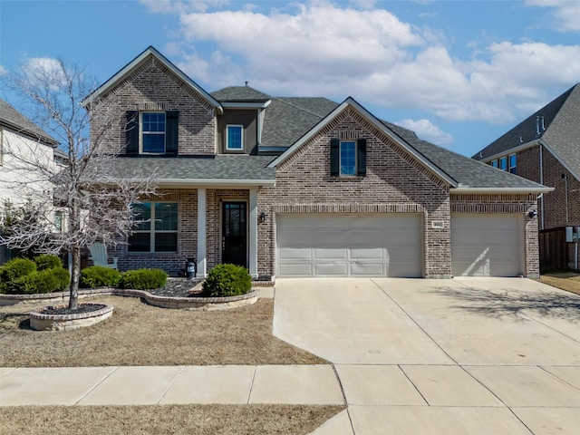 traditional home featuring driveway, roof with shingles, a garage, and brick siding