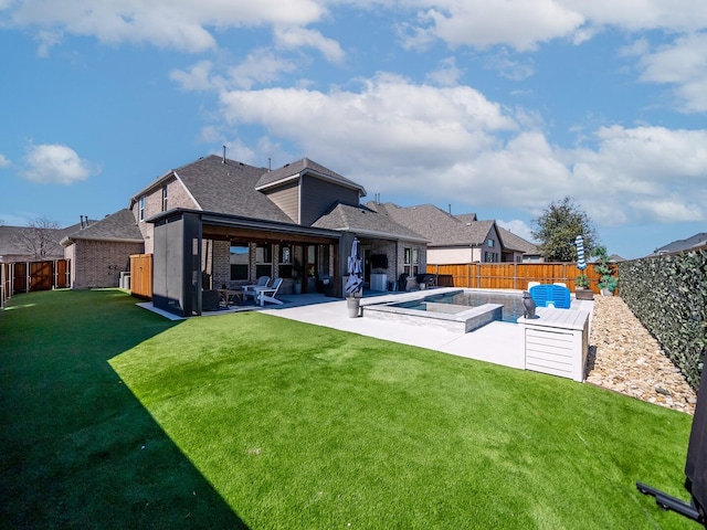 rear view of property with a patio, a fenced backyard, brick siding, a yard, and a hot tub