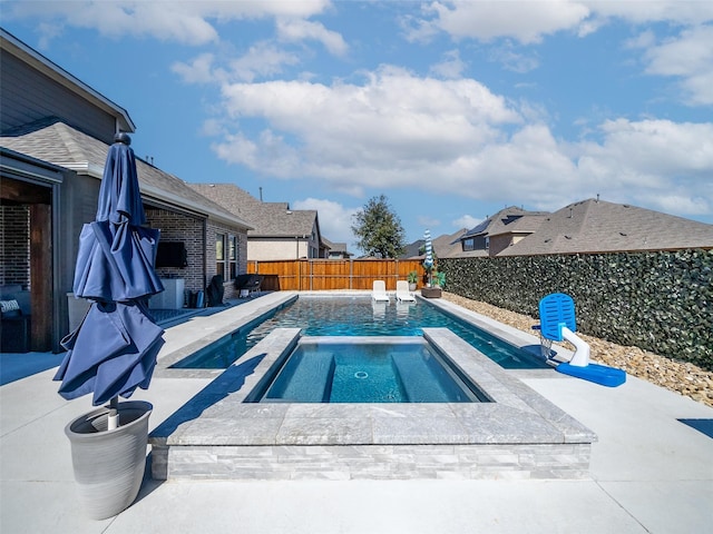 view of pool with an in ground hot tub, a patio area, a fenced backyard, and a fenced in pool