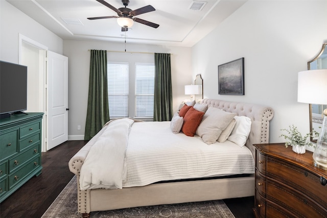 bedroom with baseboards, visible vents, ceiling fan, and dark wood-style flooring