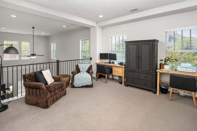 office space with light colored carpet, a healthy amount of sunlight, visible vents, and recessed lighting