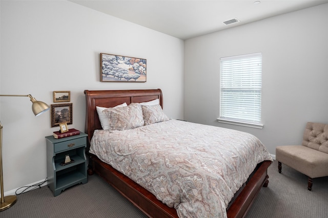 carpeted bedroom with visible vents and baseboards