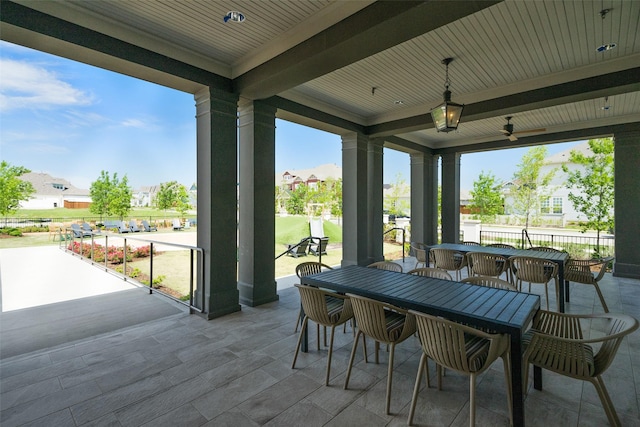 view of patio with ceiling fan, a residential view, fence, and outdoor dining space