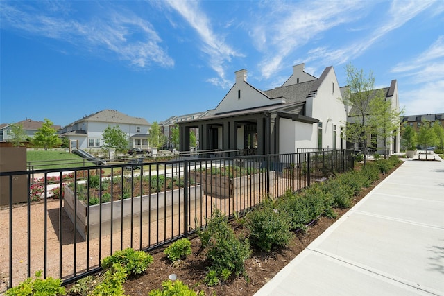 view of front of property with a residential view, fence, and stucco siding