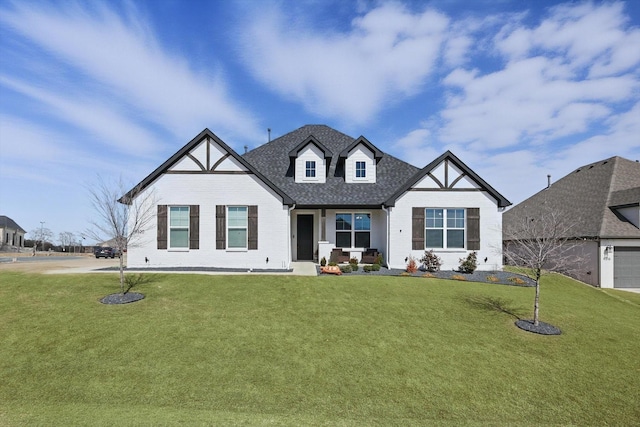 view of front of property with a front lawn and a shingled roof