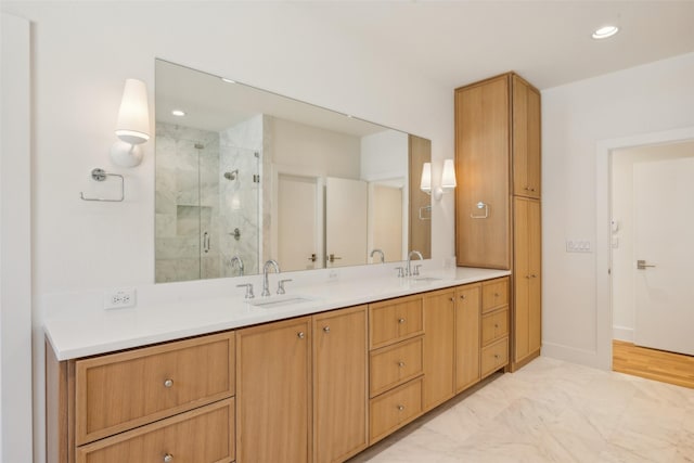 bathroom with double vanity, a stall shower, a sink, and recessed lighting