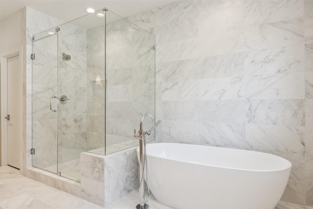 bathroom with a freestanding bath, marble finish floor, a shower stall, and recessed lighting