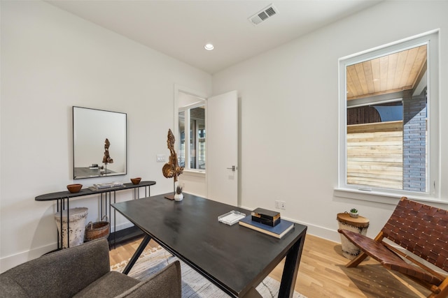 office area featuring plenty of natural light, light wood-style floors, baseboards, and visible vents