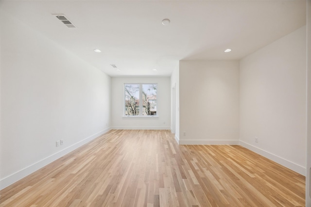 spare room featuring recessed lighting, visible vents, light wood-style flooring, and baseboards