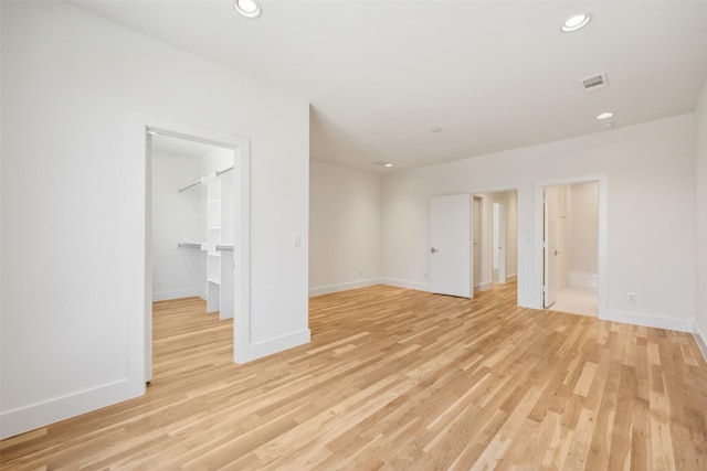 empty room featuring baseboards, recessed lighting, visible vents, and light wood-style floors