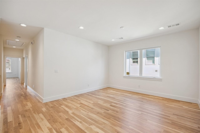 spare room with recessed lighting, light wood-style flooring, and baseboards