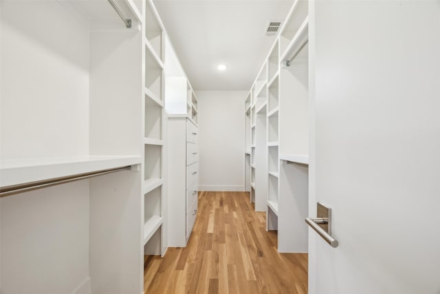 walk in closet featuring light wood-type flooring and visible vents