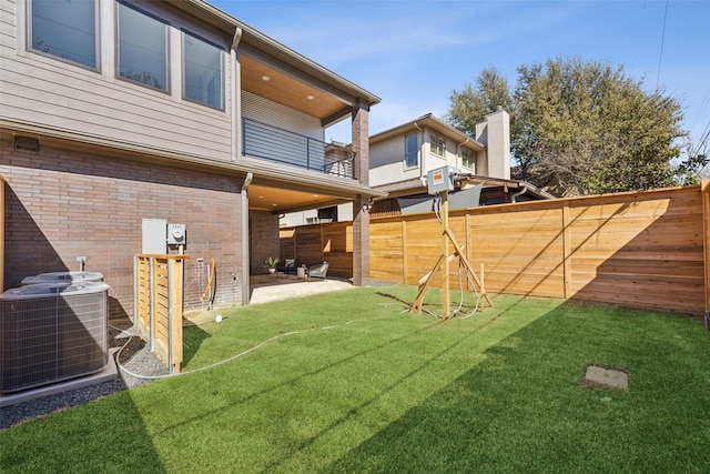 view of yard featuring a patio area, a fenced backyard, and central air condition unit