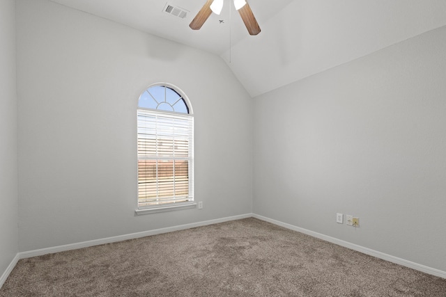 carpeted spare room featuring baseboards, visible vents, vaulted ceiling, and a ceiling fan