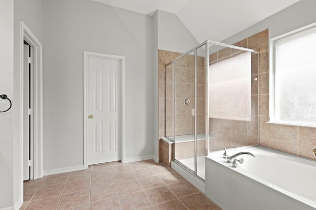 bathroom with vaulted ceiling, a stall shower, tile patterned flooring, and a bath