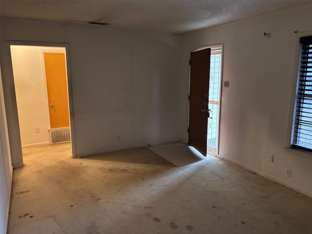 foyer featuring visible vents and a textured ceiling