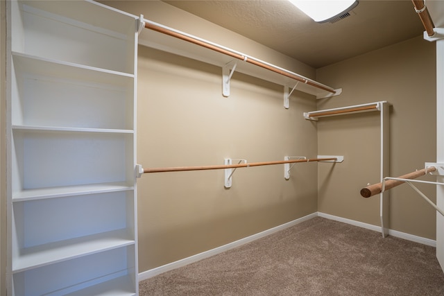 walk in closet with carpet