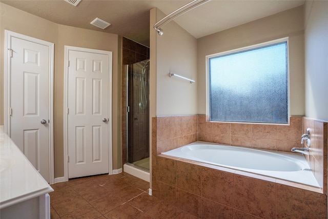 bathroom featuring a bath, a shower stall, visible vents, and tile patterned flooring