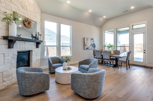 2521 Warwick Dr, Celina, TX 75009 - living area featuring lofted ceiling, wood finished floors, visible vents, and plenty of natural light