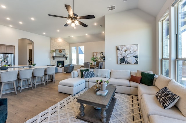 2521 Warwick Dr, Celina, TX 75009 - living area with a ceiling fan, light wood-style floors, arched walkways, lofted ceiling, and visible vents