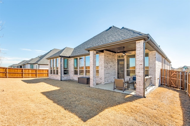 2521 Warwick Dr, Celina, TX 75009 - back of house featuring ceiling fan, a fenced backyard, brick siding, and a patio area