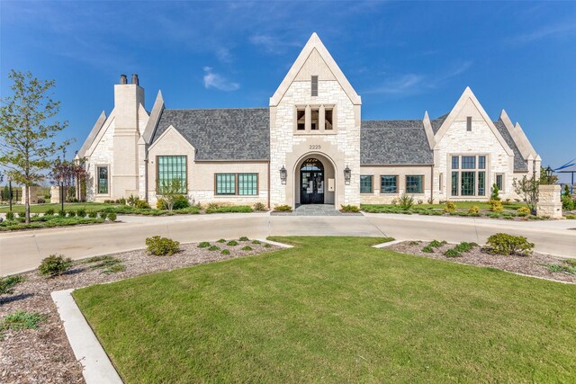 2521 Warwick Dr, Celina, TX 75009 - view of front of property with a front lawn, stone siding, and french doors