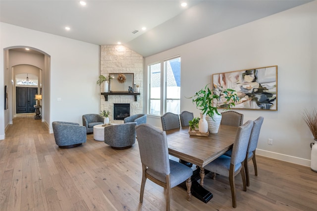 2521 Warwick Dr, Celina, TX 75009 - dining space featuring baseboards, vaulted ceiling, wood finished floors, and arched walkways