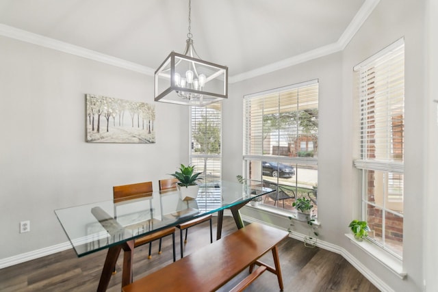 dining space featuring a chandelier, crown molding, baseboards, and wood finished floors