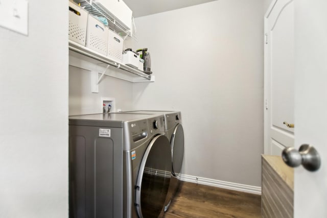 laundry room with laundry area, baseboards, dark wood finished floors, and washer and dryer