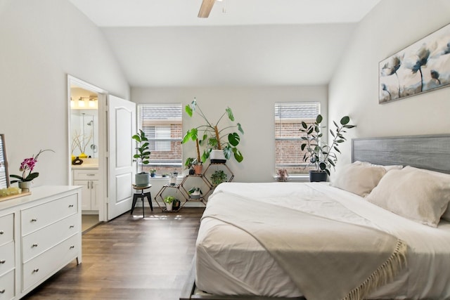 bedroom with ceiling fan, vaulted ceiling, dark wood-style flooring, and ensuite bathroom