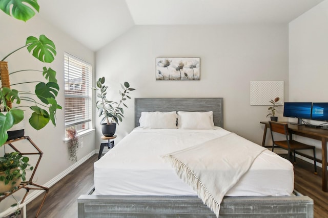 bedroom with lofted ceiling, wood finished floors, and baseboards