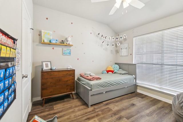 bedroom featuring a ceiling fan, vaulted ceiling, and wood finished floors