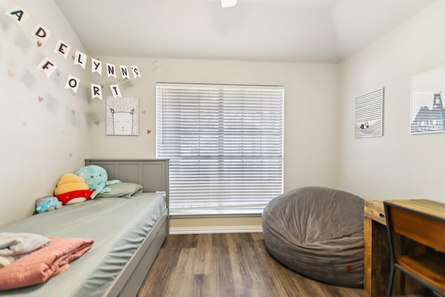 bedroom featuring baseboards and wood finished floors