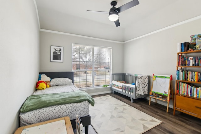 bedroom featuring ceiling fan, crown molding, and wood finished floors