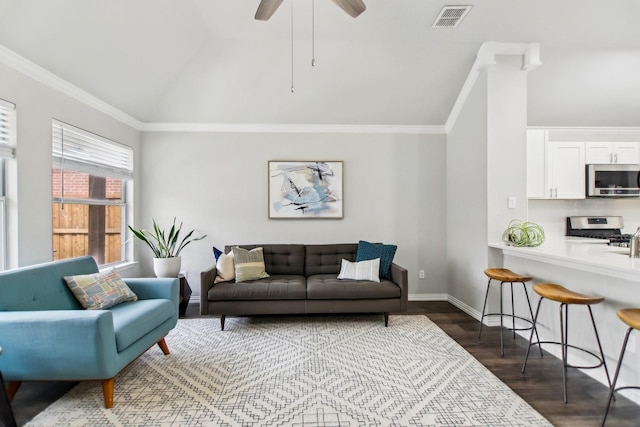 living area with ornamental molding, visible vents, vaulted ceiling, and dark wood-type flooring