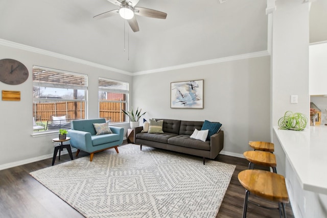 living room featuring ceiling fan, dark wood-type flooring, baseboards, vaulted ceiling, and crown molding