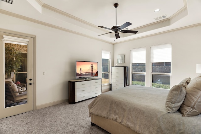 carpeted bedroom with ornamental molding, a raised ceiling, visible vents, and baseboards